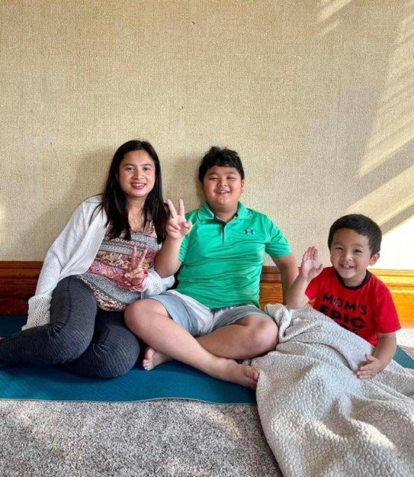 MuMu Aye sits with her sons, Andrew, 8, and Elijah, 3.