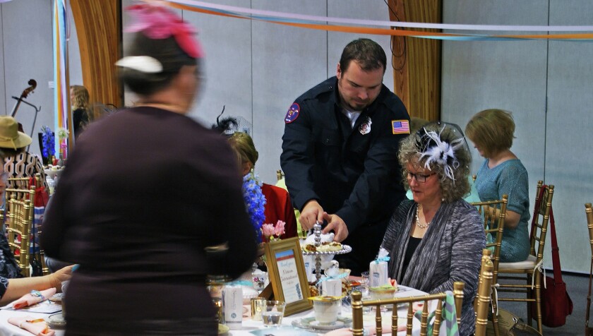 Nisswa firefighter Derek Owen pours tea at the Afternoon Tea for Hope fundraiser for Bridges of Hope on Sunday, May 3, at Lutheran Church of the Cross. Submitted Photo