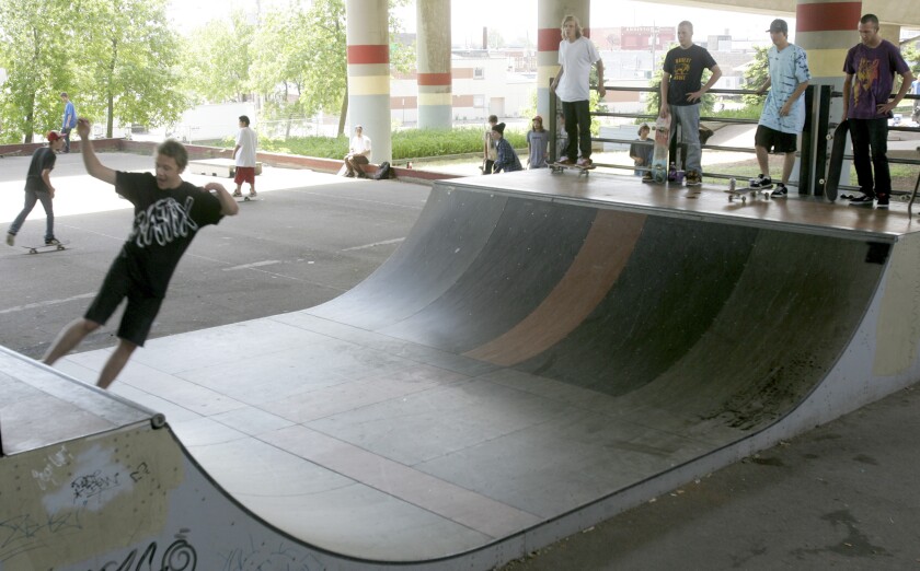 Skateboarder on a half pipe.