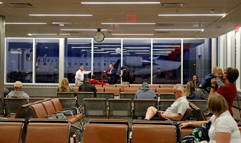 People wait to board a flight.