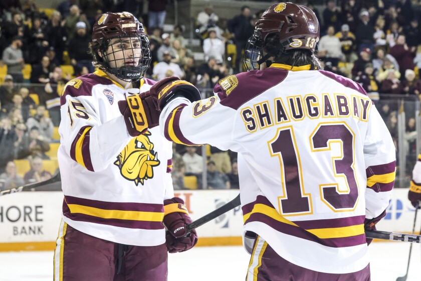 college men play ice hockey