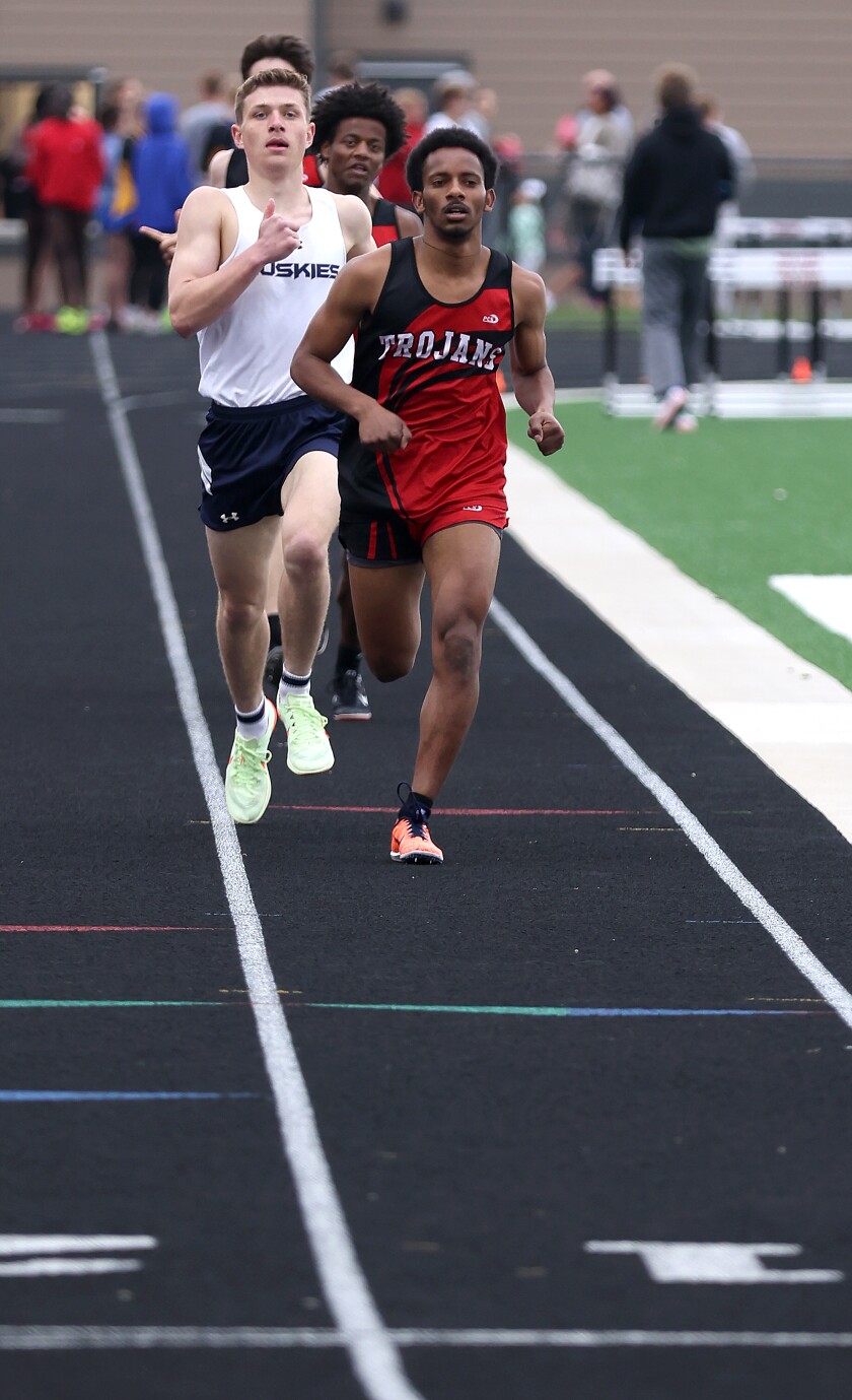 Worthington Trojans Filman Wolday sprints to the finish line in the 1600 meters race followed by Jackson county Central Huskies Andrew Boyum during Trojan Relays Tuesday afternoon in Worthington Minnesota.