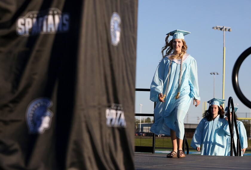 Brooke Hendry walks across the stage to get her diploma during the Superior High School graduation
