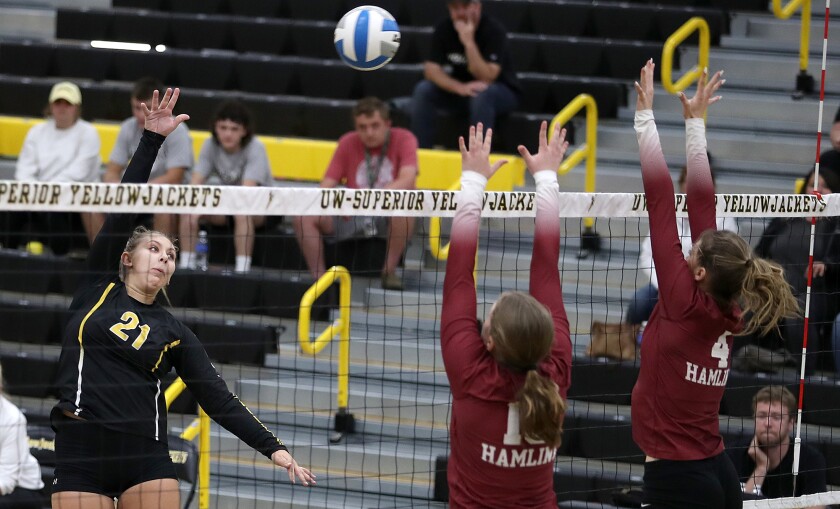 UW-Superior’s Alexie Pryd (21) pops the ball over the Hamline block