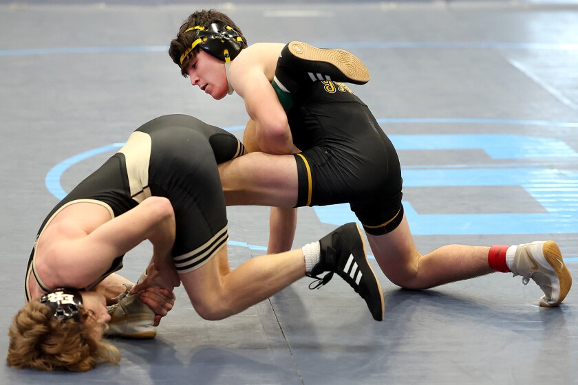 Wrestler controls leg of opponent.
