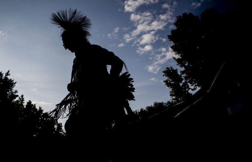 Native American dancers move around the grounds to the sounds of drums and singing during the Upper Sioux Community's traditional WACIPI on the evening of Friday, August 5, 2022.