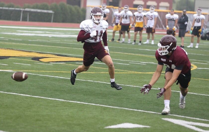 Bulldog defensive back Tim Pokornowski (41) watches as a pass meant for Dylan DeChampeau (84) falls incomplete during practice