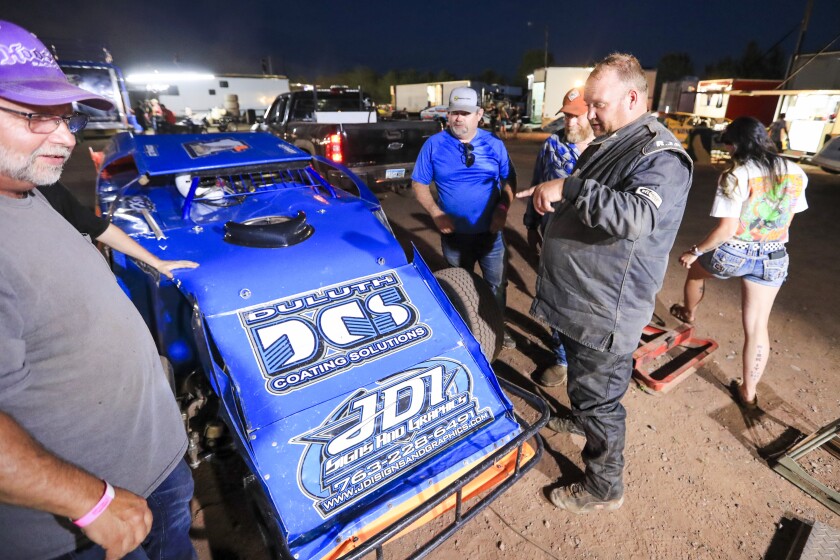 Race cars and people working on them