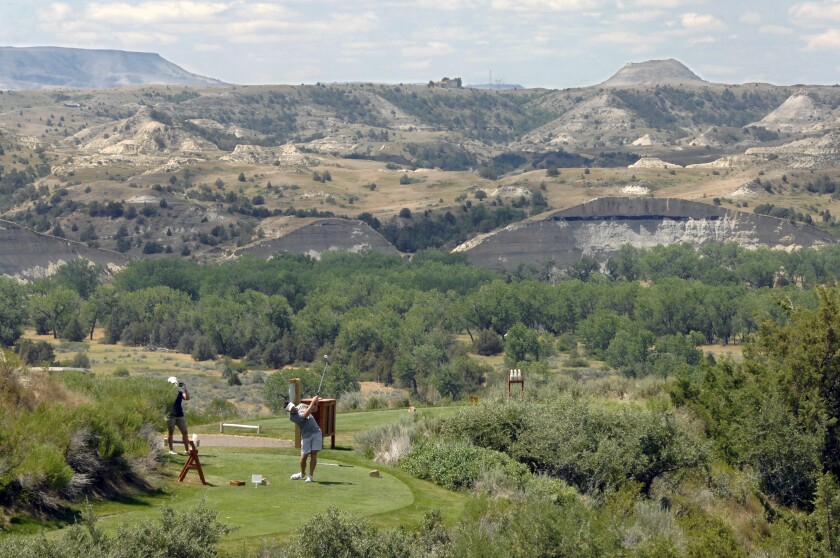 Casey Moen, golf pro at the Bully Pulpit Golf Course south of Medora, N.D., talks about the three large storage ponds near the golf course used to water the 18-hole public golf course. The water was pumped from the adjacent Little Missouri River before June 1 Moen said. (Mike Mccleary / Bismarck Tribune)