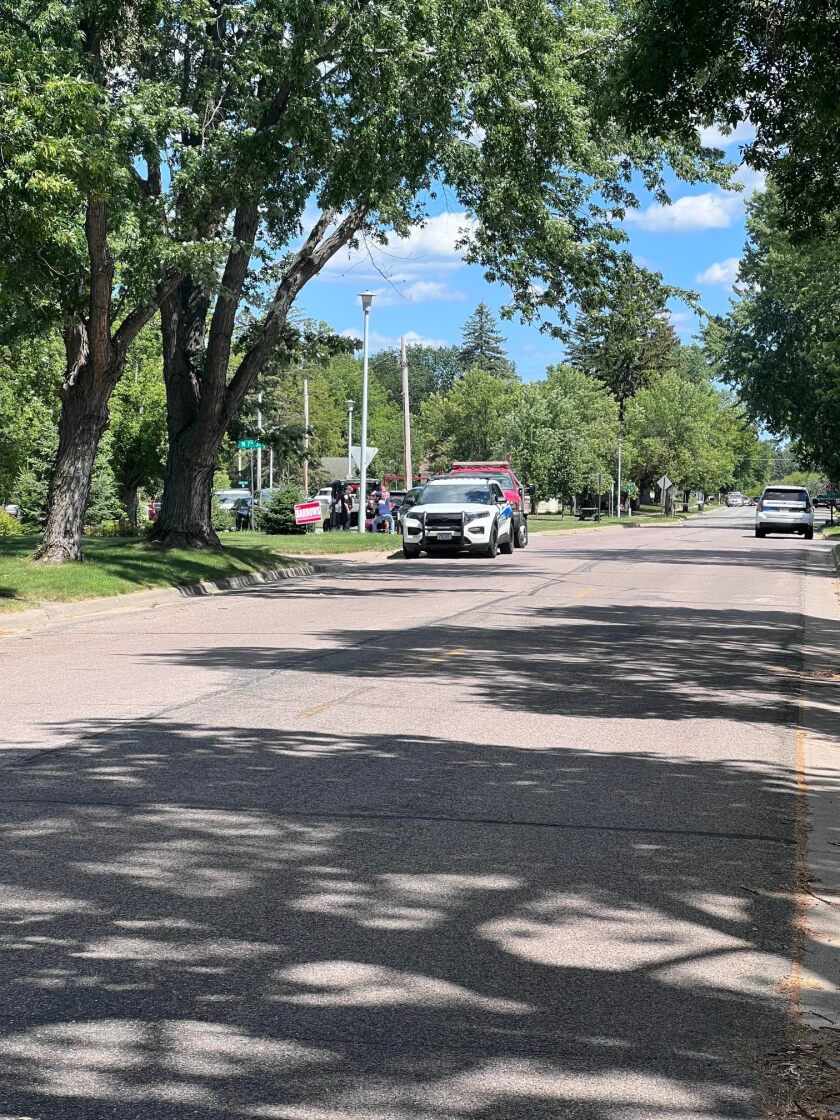 Emergency vehicles are seen on Bluff Avenue near the area where the body of a Brainerd man was found