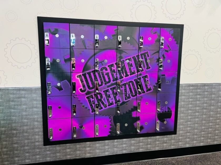 Reading in a bright purple locker "judge free zone." 