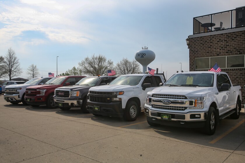 A row of pickup trucks in the lot of New Day Auto Sales on May 9, 2025. The auto dealership recently moved into a new location at 4554 7th Ave. S. in Fargo.
