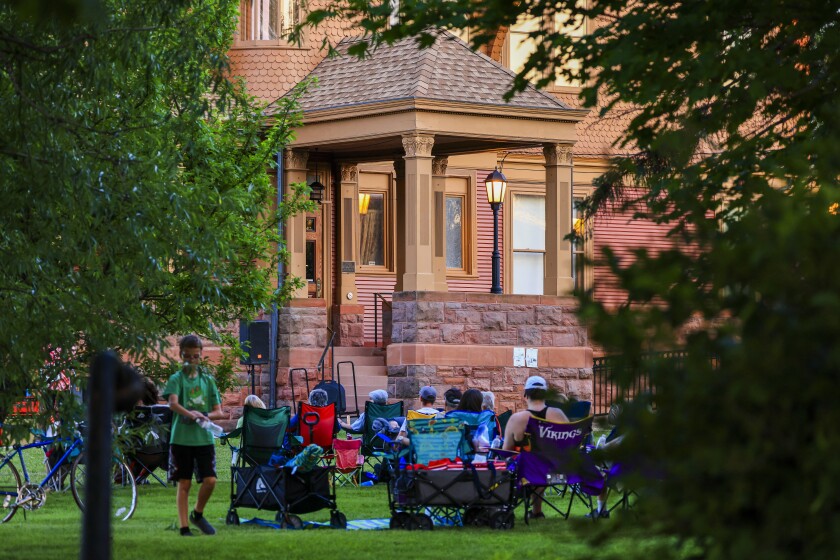 People outdoors at historic mansion