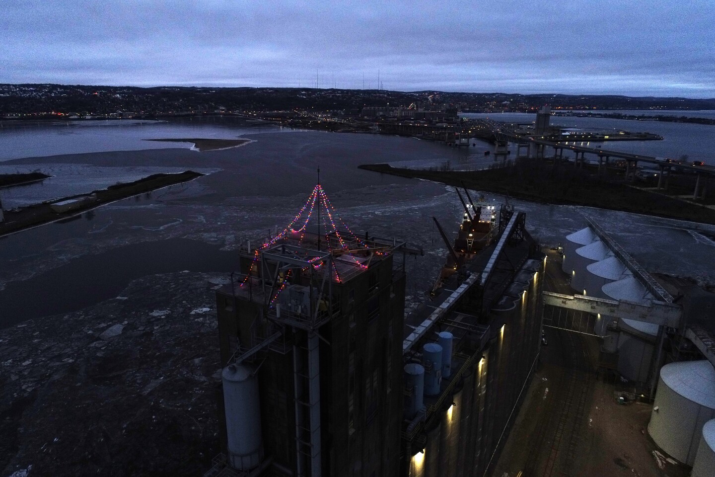 Drone view of holiday lights strung across the top of a grain elevator