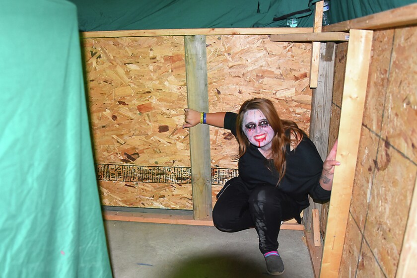 Briana Sanchez / TribuneBrianna Schmidt, Willmar Nite Lions, waits around a corner to scare people during the Deegers Freak Show hautned house Sunday night. The haunted house was put on by the Willmar Noon and Nite Lions. Regular admission is $10. Admission is $8 with the donnation of a canned food item for the Willmar Area Food Shelf.