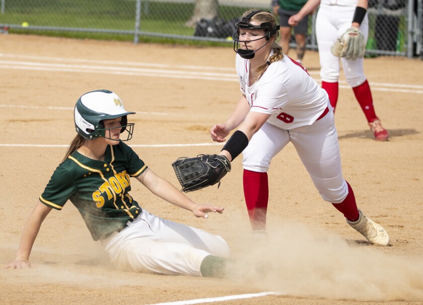 Willmar senior third baseman Marin Enstad attempts to tag out Sauk Rapids senior Chloe Reiter during a Section 8AAA playoff game in Willmar on Tuesday, May 24, 2022.
