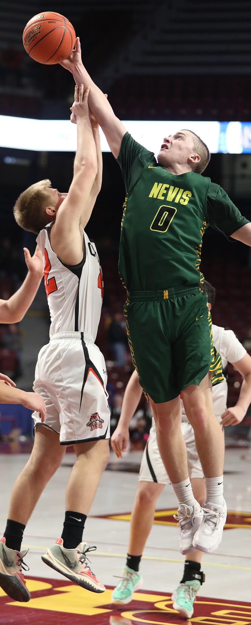 Nevis’ Mathias Warrington (0) tips a rebound away from Cherry’s Kaleb Rinerson (42)