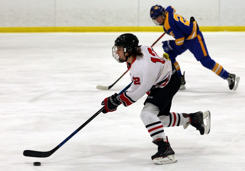 Worthington Trojans Ian Bumgardner (12) takes a fast break down the Ice pursued by visiting Windom Eagles Ethan Rabbe during a Monday evening game.