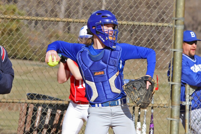 Softball catcher throws the ball.