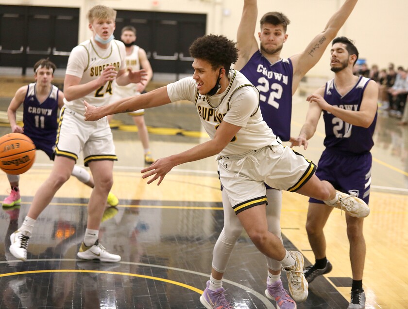 UW-Superior’s Xavier Patterson (3) passes around the Crown defense