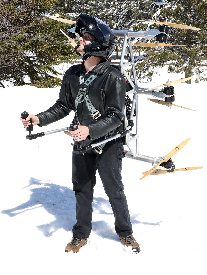 Ascend Dynamics, LLC founder, Daniel Gant, looks to the sky as he wears a prototype of his SkyPak, a propeller-driven jetpack
