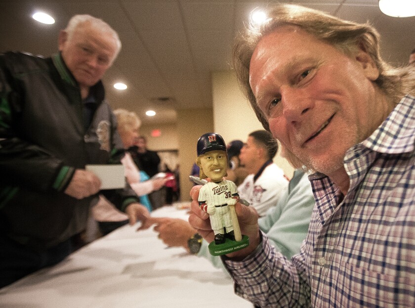 Dan Gladden, Minnesota Twins color commentator and member of the 1987 and 1991 World Series champion Twins, signs a Bobblehead of himself during the Twins Winter Caravan stop at the Ramada Inn Tuesday in Grand Forks. photo by Eric Hylden/Grand Forks Herald
