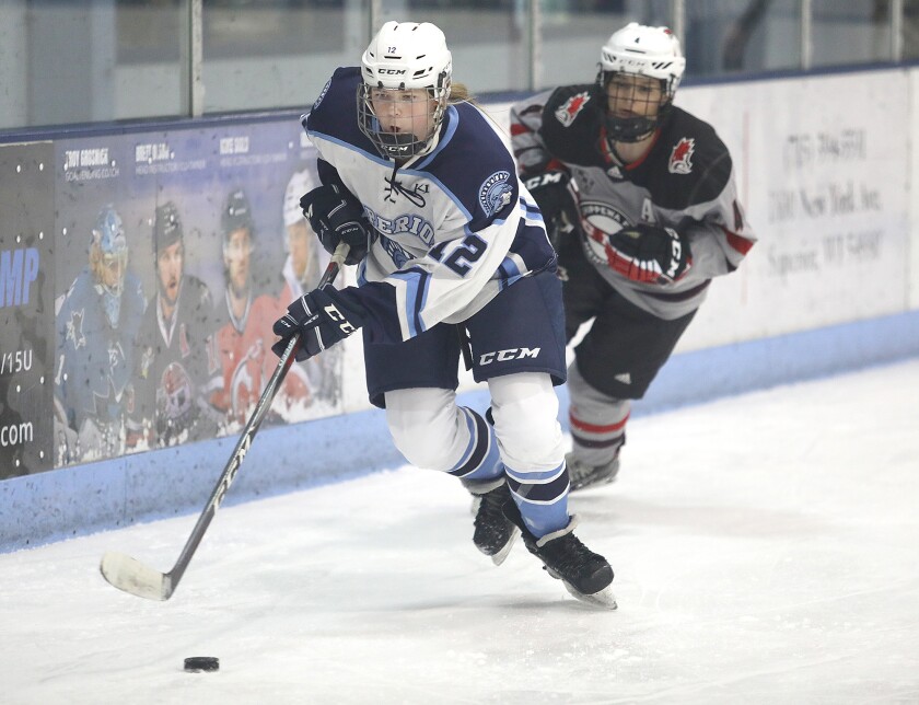 Superior’s Grace Hansen (12) moves the puck out of the Spartans defensive zone