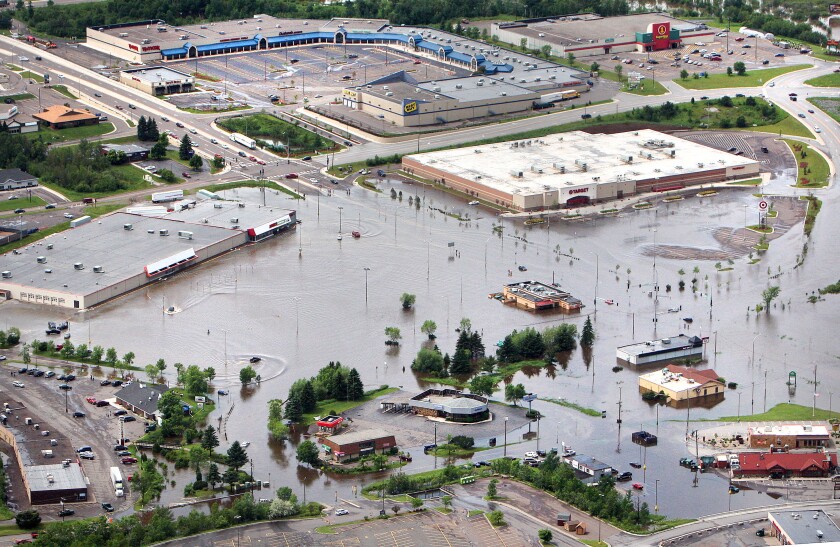 Aerial view of flooded parking lots in a mall area