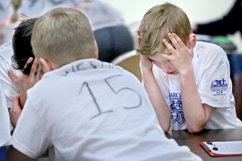 Lester Park fifth-grader Soren Hanhan of the Flaming Hawks team presses his hands against his forehead as he and his teammates struggle to remember the name of the book and author during the school's Battle of the Books on Friday. Bob King / rking@duluthnews.com