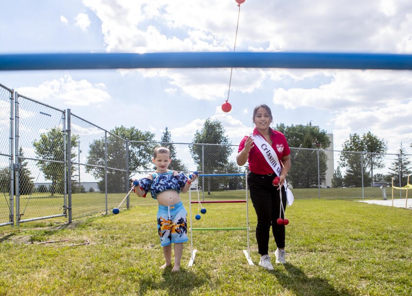 Willmar Fest candidate Cresstill Duaso, at right, plays redneck golf with Blane Wendt, 5, during the Queen's Splash at the Dorothy Olson Aquatic Center on Wednesday, June 22, 2022.