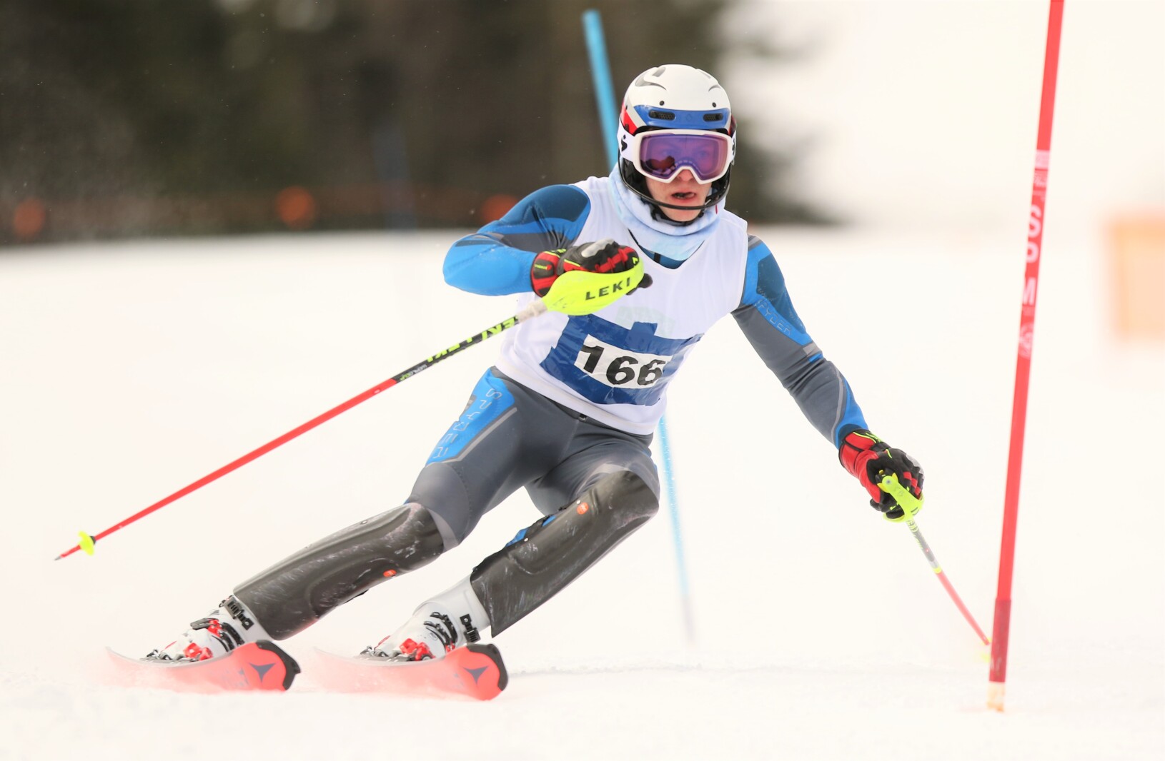 A downhill skier moves down the hillside.