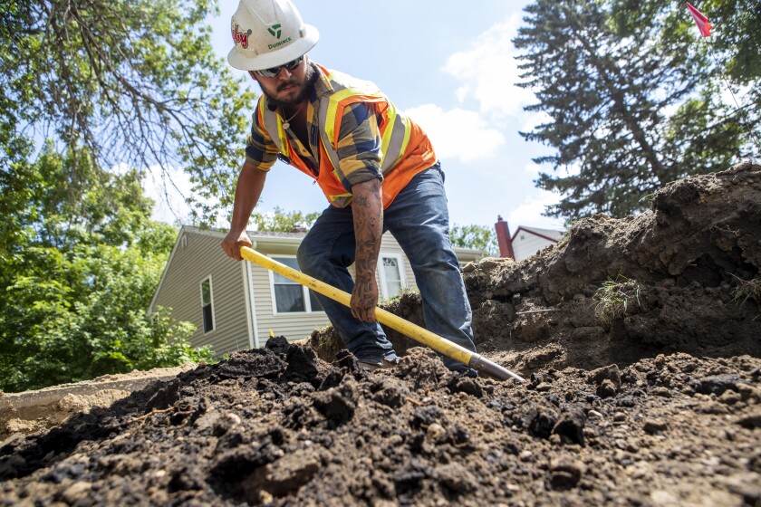 Winston Hearn of Duininck digs while looking for utility lines along Charlotte Street SE on Tuesday, August 16, 2022.
