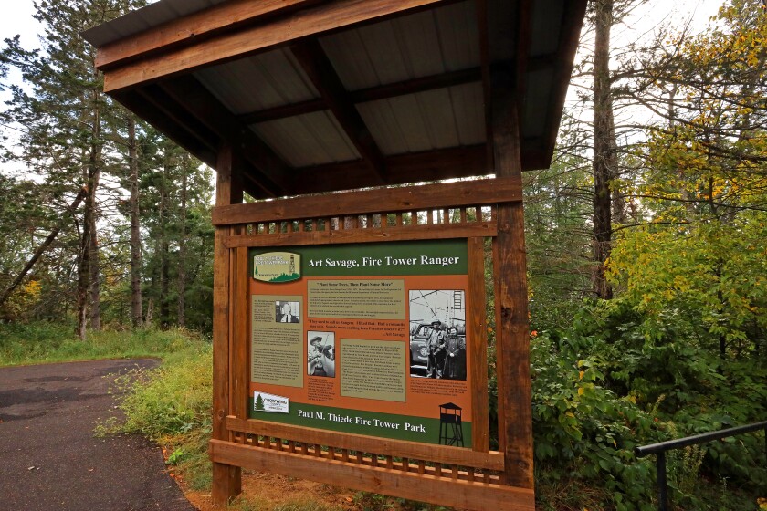 A tribute kiosk to Art Savage, a Minnesota Department of Natural Resources forester, is located at the base of the Pequot Lakes fire tower for his more than three decades of service to the community.