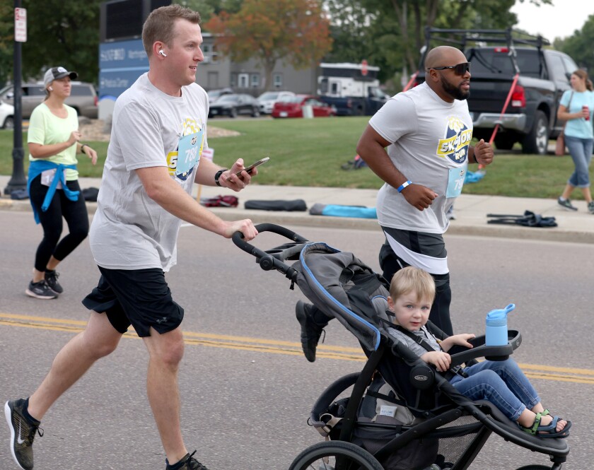 Runners in the 5K race jog by during the annual Worthington Area YMCA 10K, 5K, and untimed family walk Saturday morning Worthington's King Turkey Day Celebration.