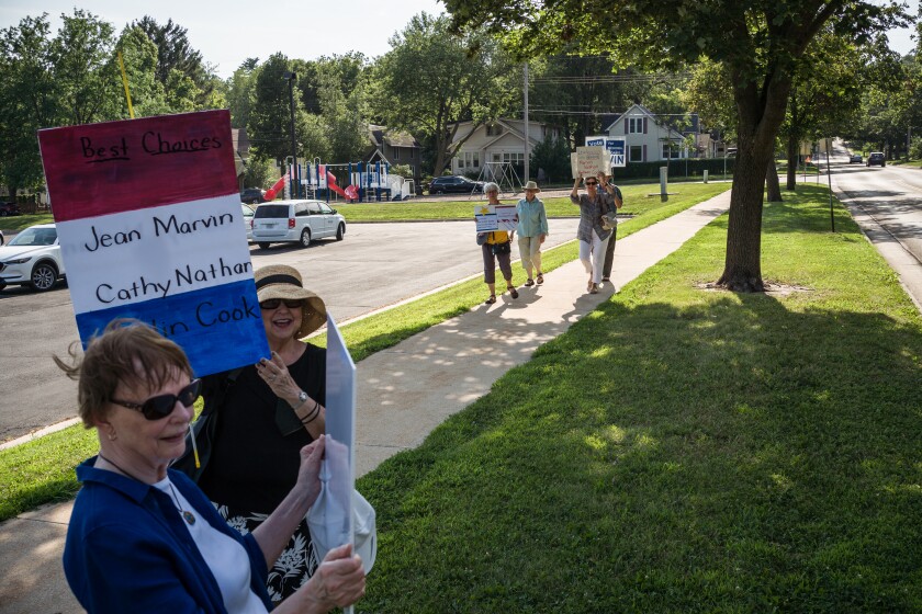 Photos Supporters for opposing school board candidates rally at the