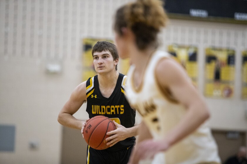 Wildcats sophomore Grant Paffrath looks for an open teammate while taking on Howard Lake-Waverly-Winsted Friday, Feb. 4, 2022 in New London.