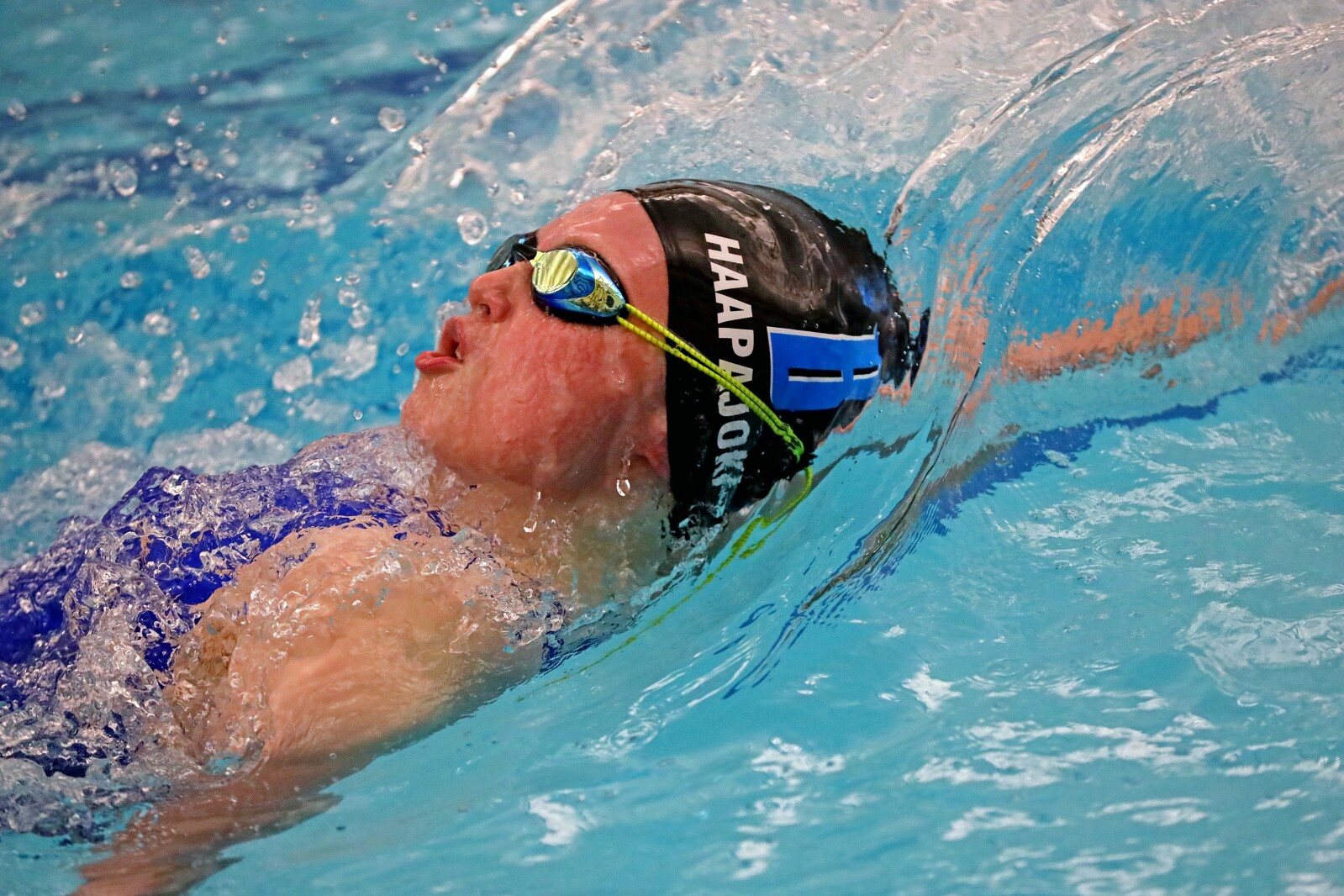 A close shot of a swimmer with water splashing.