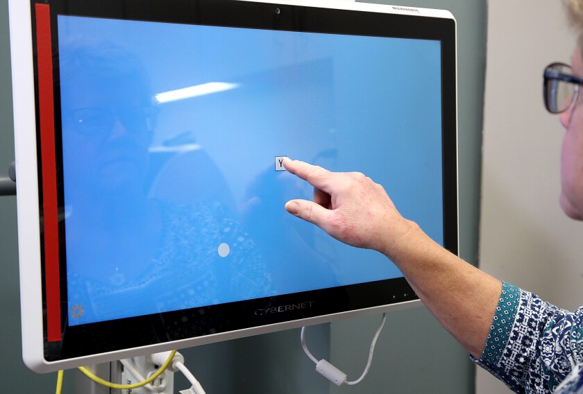 Woman's finger touches the letter Y in the middle of a computer screen.