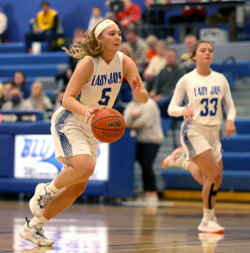 Minnesota West's Madisyn Huisman (5), flanked by teammate Dannyn Peterson (33), dribbles down court for a layup during a Saturday afternoon game with the St. Cloud Tech Cyclones. West won, 70-54.