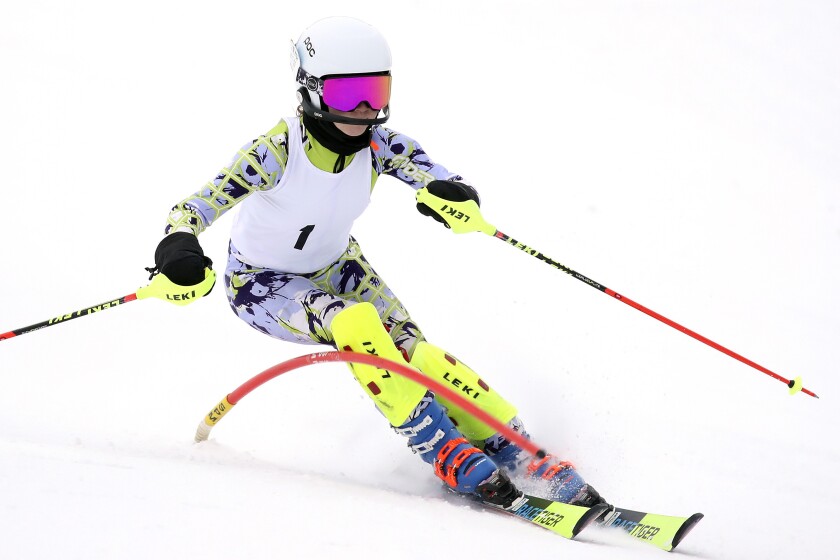 Skier races around a gate.