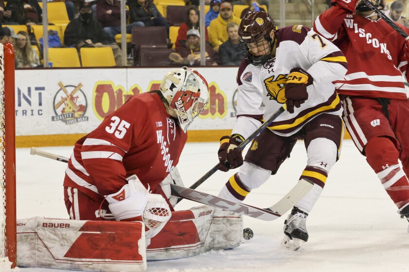 college hockey players play ice hockey