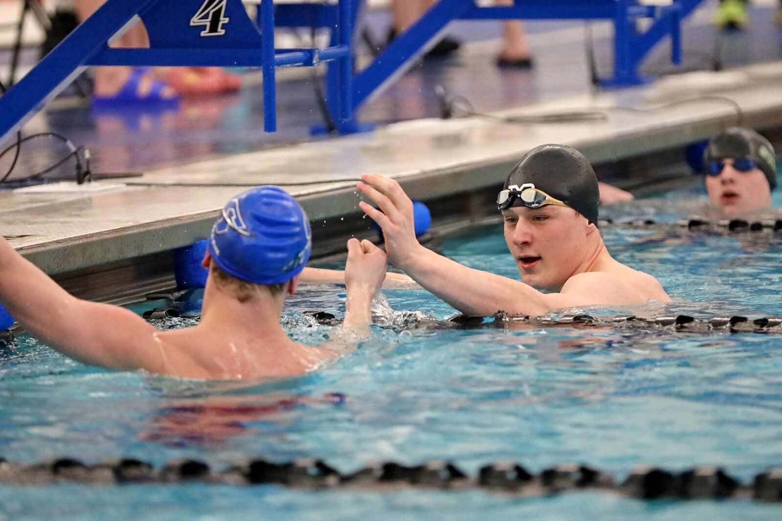 Swimmers congratulate each other after a good swim.