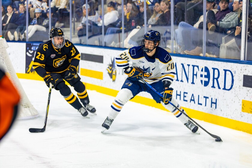 Augustana's Jacob Jastrzebski skates with the puck while being pursued by Colorado College's Mats Lindgren on Saturday, Jan. 3, 2026, at Midco Arena in Sioux Falls.