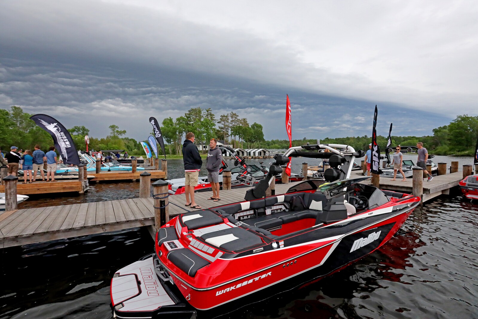 People gather for the ninth annual Bar Harbor In-Water Boat Show on Saturday, June 18, 2022, with boats from Nisswa Marine and Minnesota Inboard Water Sports at the Bar Harbor Supper Club on Gull Lake.