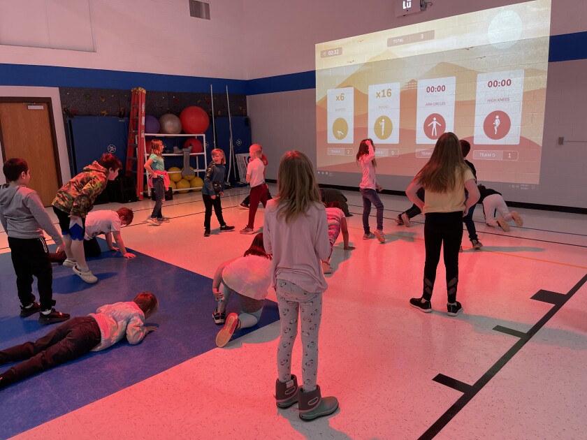 Heart River Elementary students do burpees during gym class using the interactive playground on Tuesday, May 3, 2022.