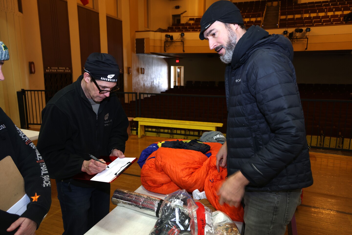 Volunteer checks racer's equipment bag