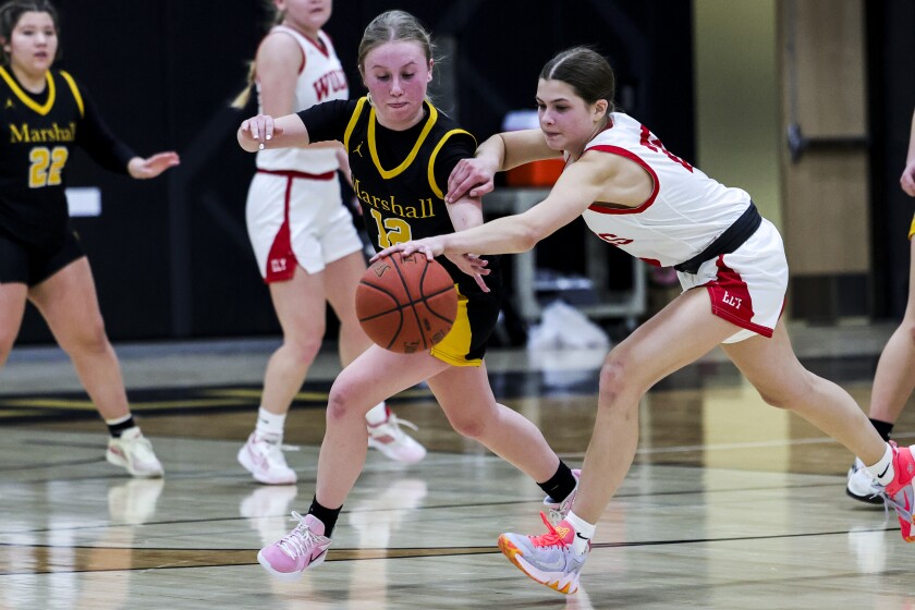 high school girls play basketball