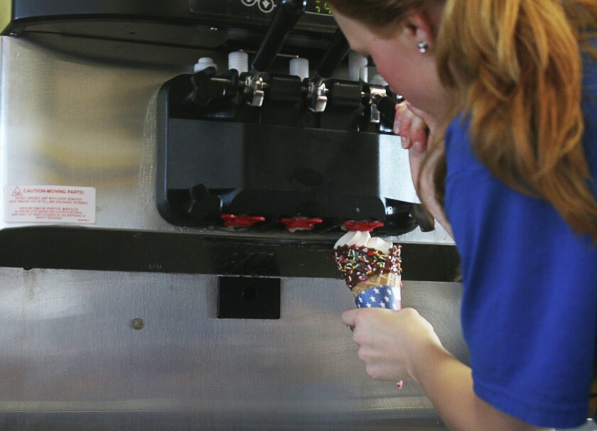 A Zesto employee makes an ice cream cone for a customer Thursday at the business in Mitchell. (Caitlynn Peetz/Republic)
