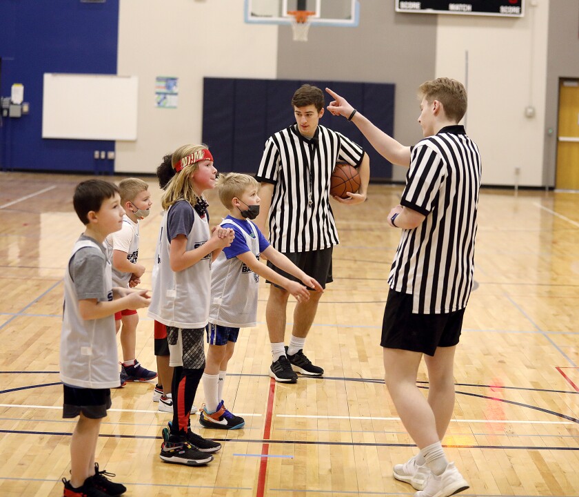 Players in the SBA’s Mini-Ballers league listen to Spartan basketball players and refs, Robert Olson, left and Evan Bennett