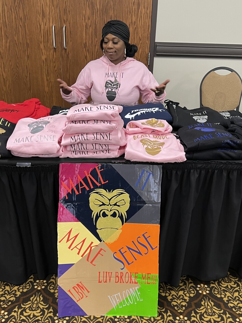Yolanda Davis, the owner of LBM (Luv Broke Me), poses with her apparel in Apache Mall.